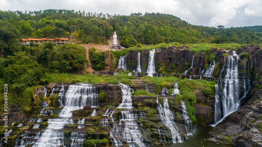 Fototapeta premium Aerial view for beautiful Pongour waterfall in Vietnam. Amazing vietnamese nature with Buddha on the top of waterfall