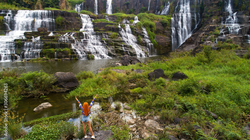 Aerial view for travel girl near beautiful Pongour waterfall in Vietnam. Travelling concept .Beautiful nature background. photo