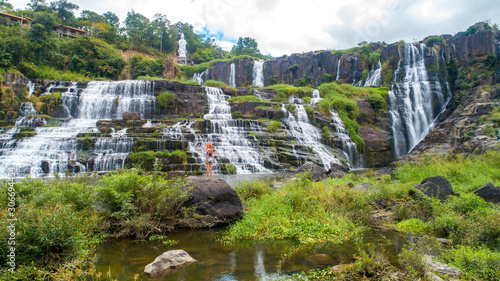 Aerial view for travel girl near beautiful Pongour waterfall in Vietnam. Travelling concept .Beautiful nature background. photo