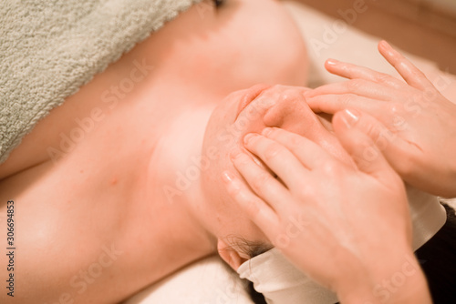 Wallpaper Mural Beautiful young woman getting a face massage treatment at beauty salon Torontodigital.ca