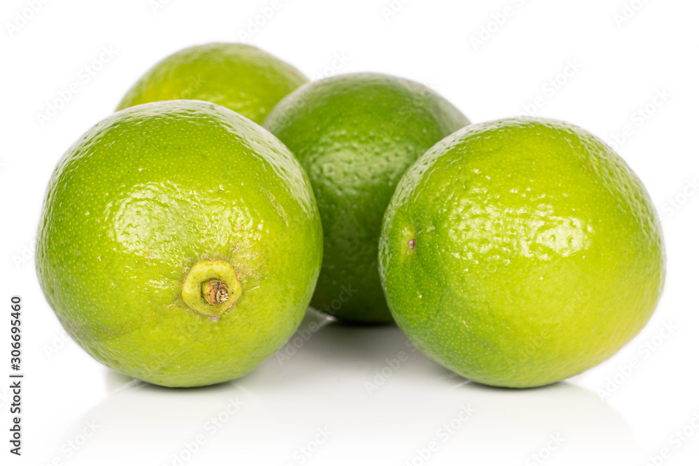 Group of four whole sour green lime isolated on white background Group of four whole sour green lime isolated on white background