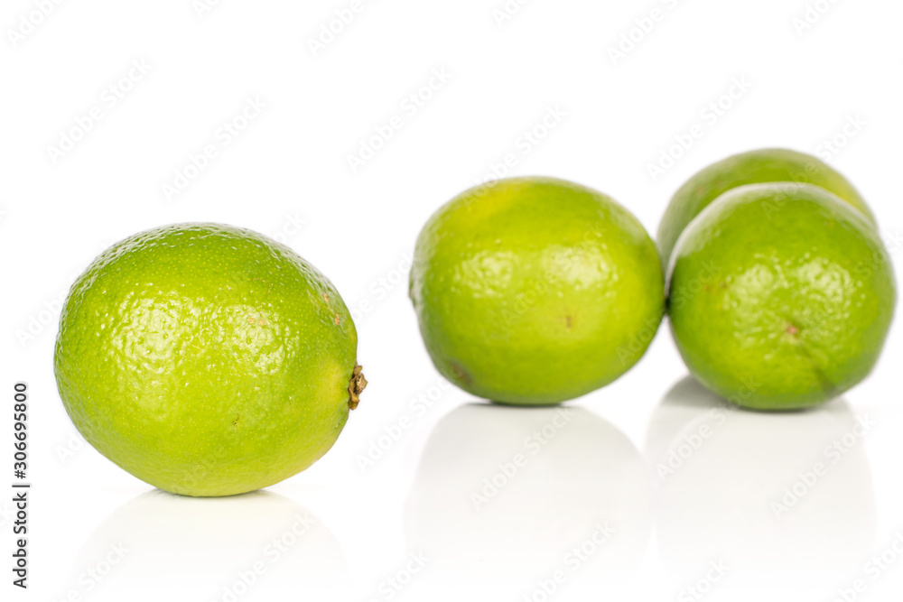 Group of four whole sour green lime isolated on white background Group of four whole sour green lime isolated on white background
