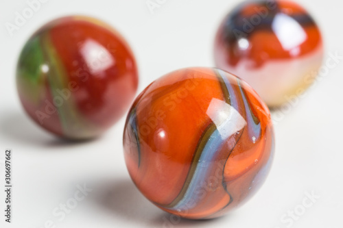 group of opaque glass marbles in orange-red © seramoje