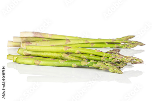 Lot of whole healthy green asparagus heap isolated on white background
