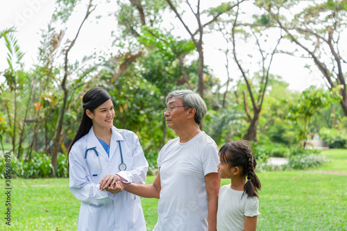 Nurse is holding the elderly hands, Take care and healthcare consultant in the park, Healthcare concept. © amorn
