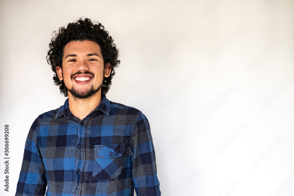 Latin American man smiling, neutral background  - obrazy, fototapety, plakaty 