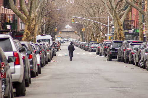 A man walks alone in an empty street at Brooklyn, New York