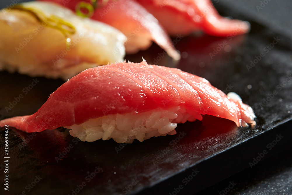 Bonito and tuna sushi on black plate Bonito and tuna sushi on black plate