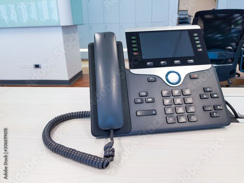 IP phone device on work office table desk background. Communication Technology to connect and call for business use in digital era in corporate company use. Professional device for call, conference. photo