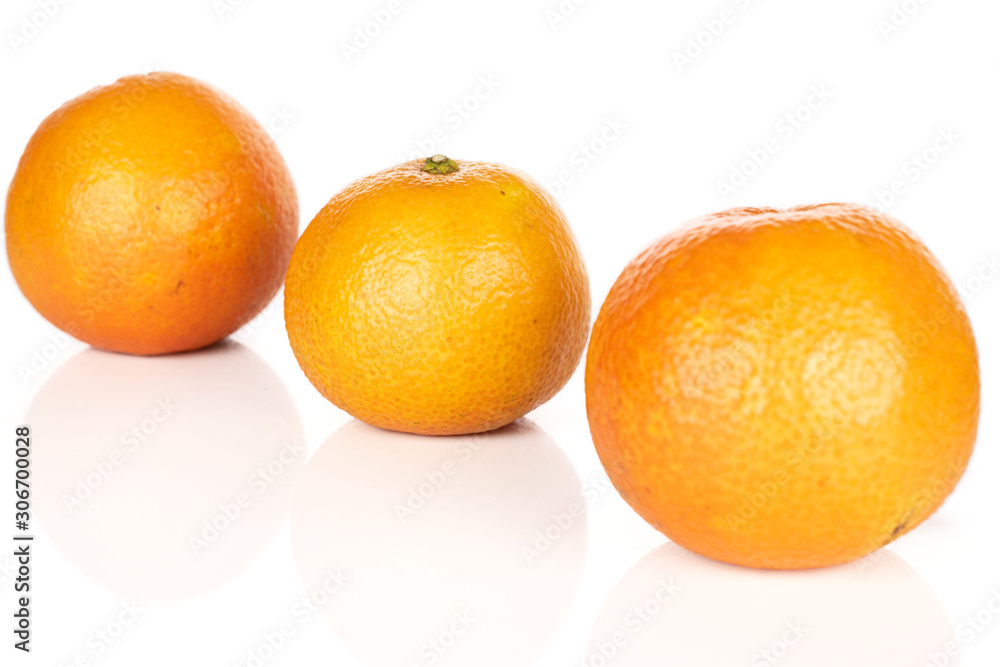 Group of three whole fresh orange mandarin diagonal isolated on white background Group of three whole fresh orange mandarin diagonal isolated on white background
