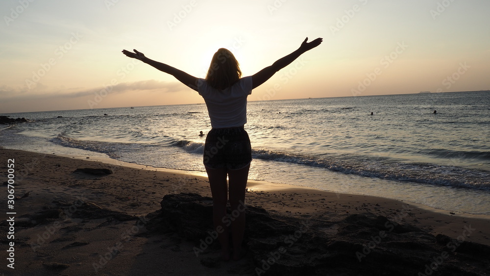 girl standing at the beach sunset thailand koh lanta