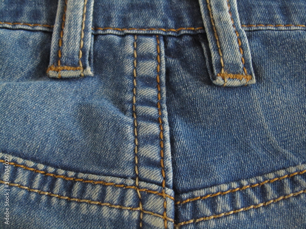 Blue jeans background. Double stitch denim texture. Jeans back view. Close-up. Indigo. Blue jeans background. Double stitch denim texture. Jeans back view. Close-up. Indigo.