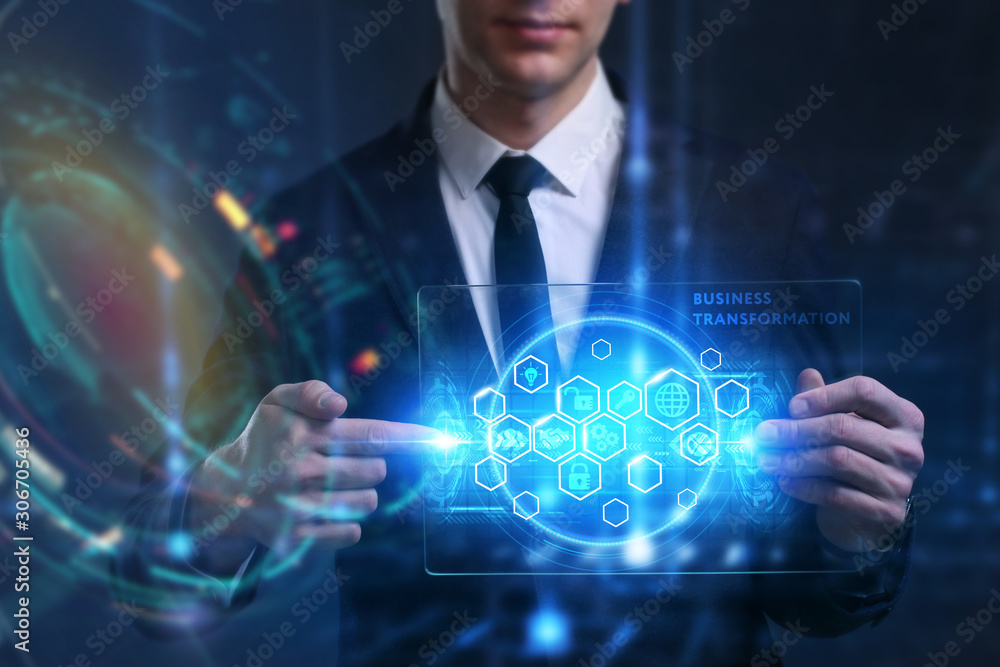 Business, Technology, Internet and network concept. Young businessman working on a virtual screen of the future and sees the inscription: Business transformation Business, Technology, Internet and network concept. Young businessman working on a virtual screen of the future and sees the inscription: Business transformation