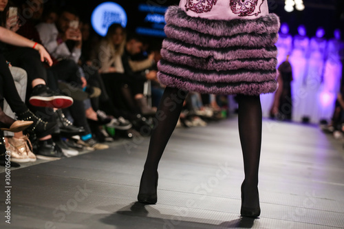 Model walk the runway at Fashion Show. Legs of model on catwalk runway show event.