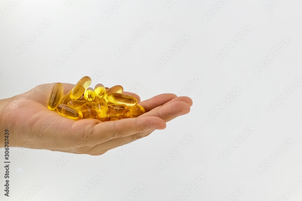 Fototapeta premium Evening Primrose oil capsules in hand which contains omega-6 fatty acids.