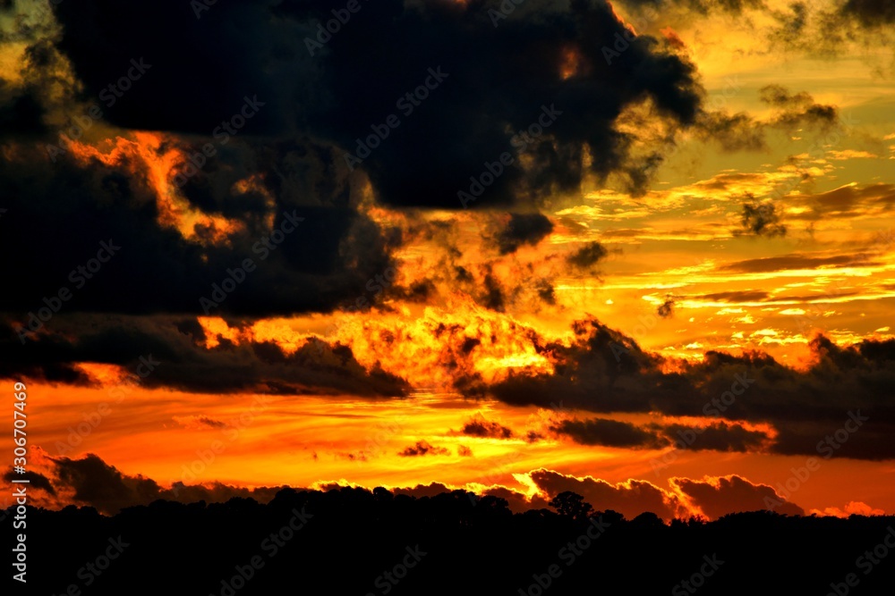 Vibrant Sunset with cloud silhouette background
