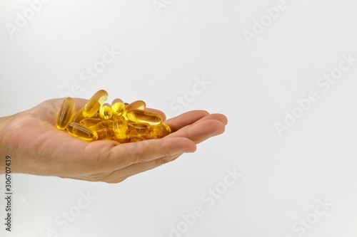 Evening Primrose oil capsules in hand which contains omega-6 fatty acids.