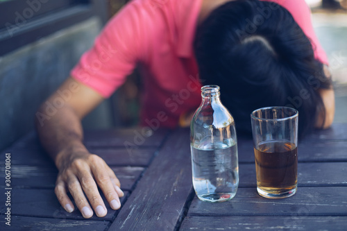 Alcohol addicted man sleeping at the table