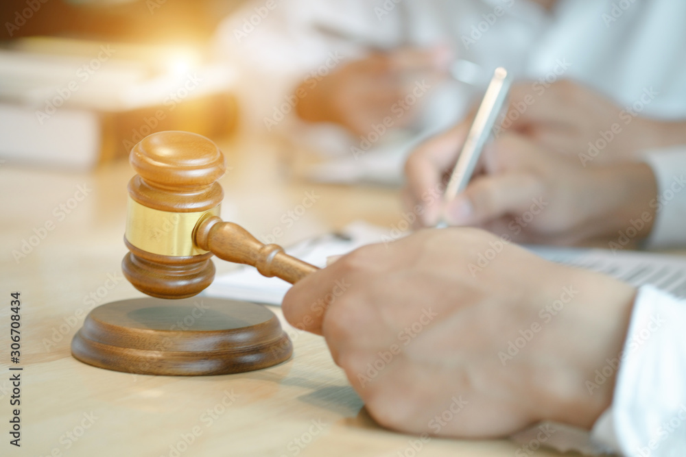 smart lawyer holding stamp for submit documents with advice in the office before considering the judgment, lawyer concept smart lawyer holding stamp for submit documents with advice in the office before considering the judgment, lawyer concept