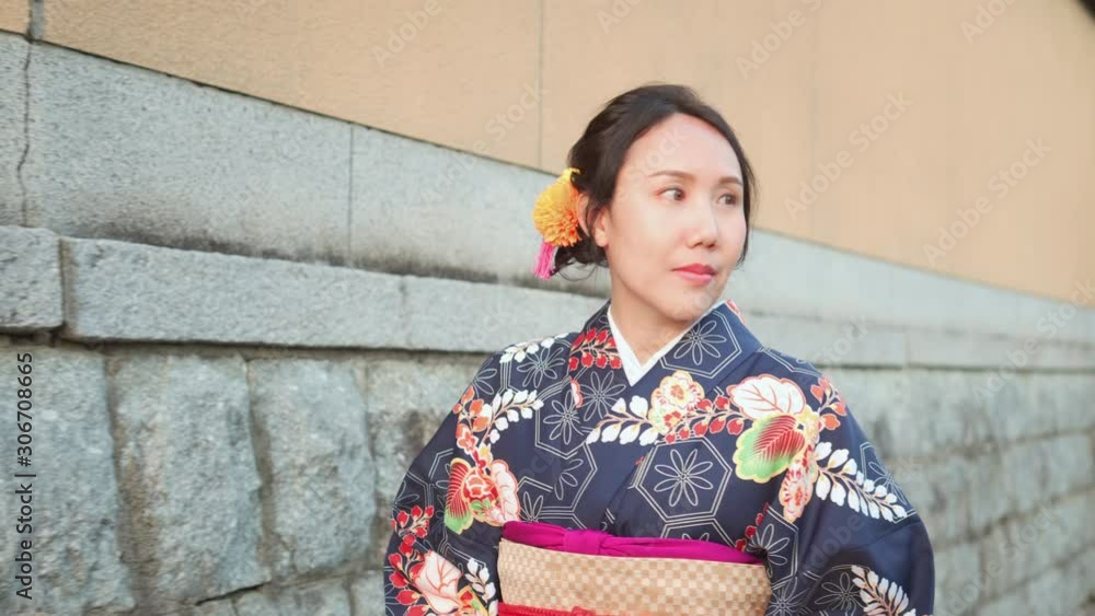 4k Young girl wearing Japanese kimono walking in town Kyoto Japan. The word 4k Young girl wearing Japanese kimono walking in town Kyoto Japan. The word