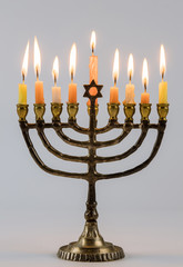 Closeup of a burning Chanukah candlestick with candles Menorah