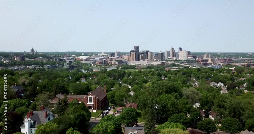 Wide aerial view of St. Paul's city skyline with suburban neighborhoods in the foreground. Wide aerial view of St. Paul's city skyline with suburban neighborhoods in the foreground.