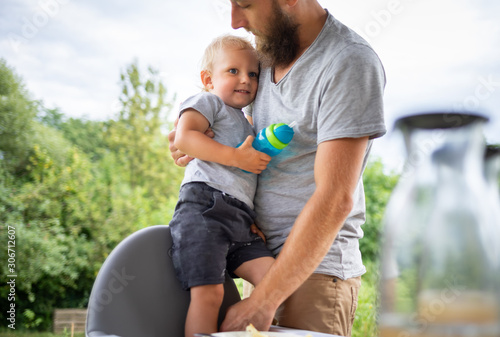 Cute toddler boy with his dad outdoor