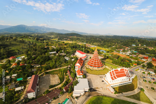 Top view of hyua pla kang temple in Chaing rai, Thailand. Bird eye view of Chaing rai temple with mountain and blue sky photo