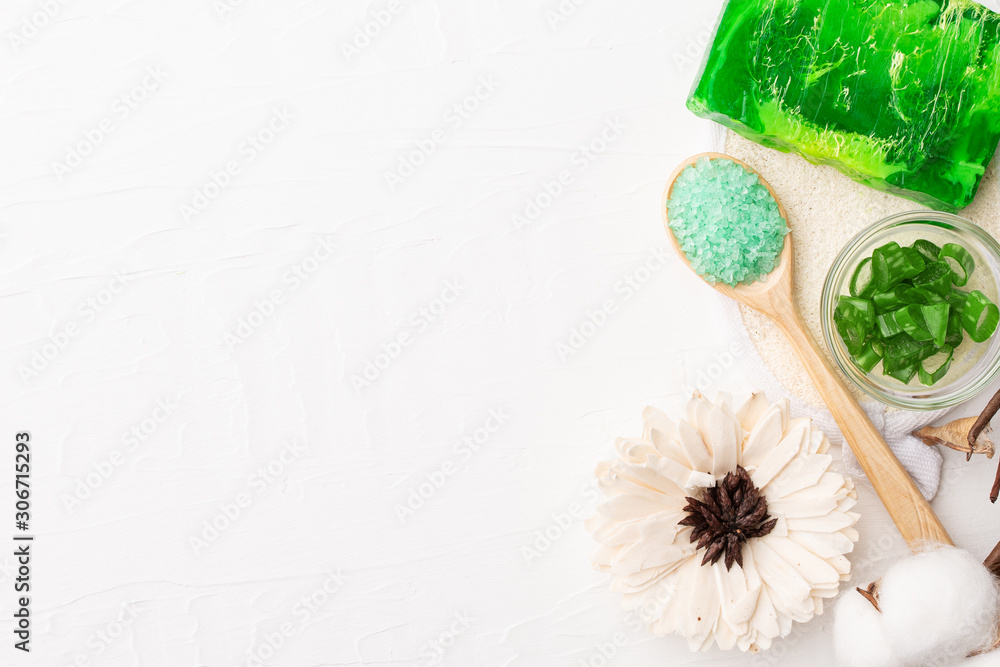 spa composition for body care on white wooden background with free copyspace mockup. Skin care handmade product cosmetics for bath. Aloe vera craft soap and bath salt spa composition for body care on white wooden background with free copyspace mockup. Skin care handmade product cosmetics for bath. Aloe vera craft soap and bath salt