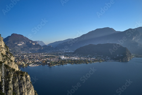 Steep cliff, view of the city of Riva del Garda, Italy. Panoramic view of Lake Garda in the foreground, the city is surrounded by rocks and alpine mountains. Autumn season. © Berg