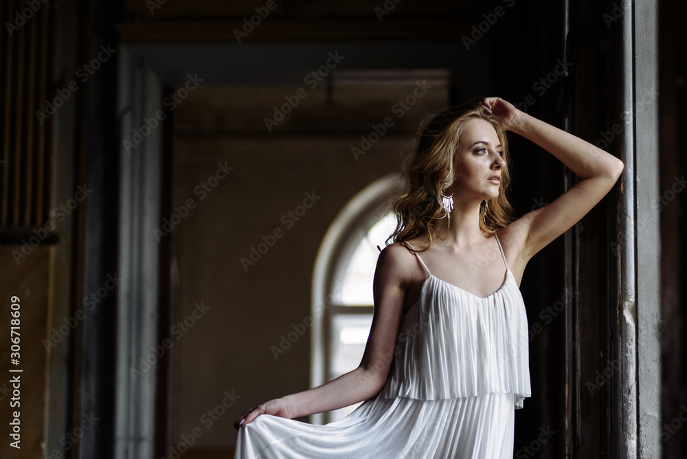 Side portrait of caucasian brunette with long hair and bright make-up in castle Side portrait of caucasian brunette with long hair and bright make-up in castle