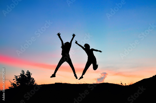 Silhouette of Teens jump on sunset time