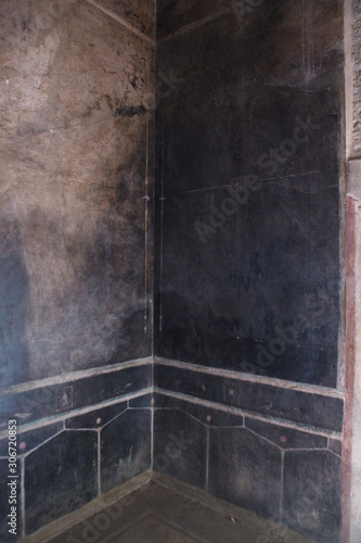 Black fresco on the wall in villa of the mysteries in Pompeii (Pompei)