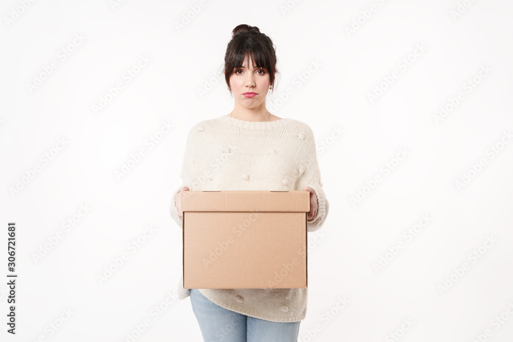Sad and upset woman holding cardboard with online order and copy space for handwriting mockup. Moving day concept. Lay out home stuff for it's place. Return package to sender. Sad and upset woman holding cardboard with online order and copy space for handwriting mockup. Moving day concept. Lay out home stuff for it's place. Return package to sender.
