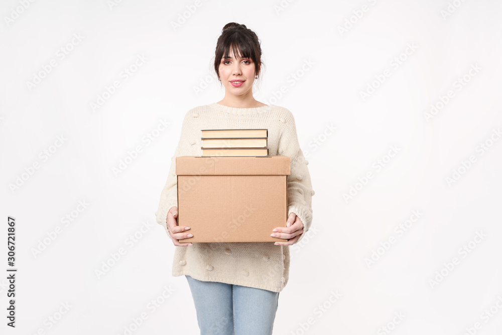 woman holding cardboard full of books with copy space for handwriting. Moving day concept. Delivery of online order. packing of textbooks woman holding cardboard full of books with copy space for handwriting. Moving day concept. Delivery of online order. packing of textbooks