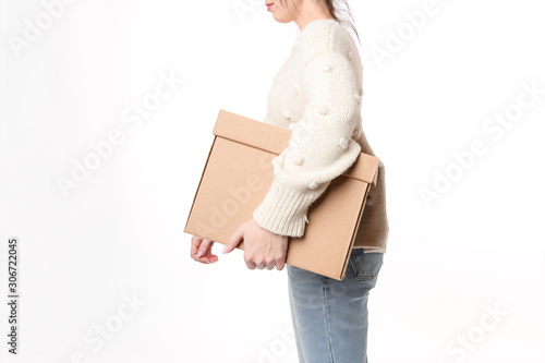 Close up hands of smiling woman holding cardboard with  copy space for handwriting. Moving day concept. Delivery of online order. Side view