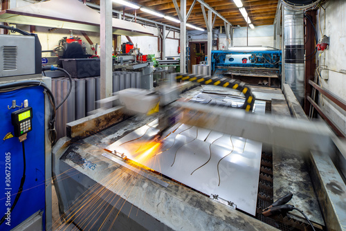 Plasma cutting of metal. View of working machine with sheet of metal. Metalworking. © Aleks Kend