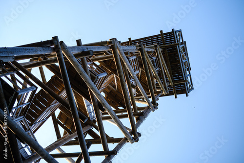 wooden stairs to watch tower in wet colored autumn day in countryside photo