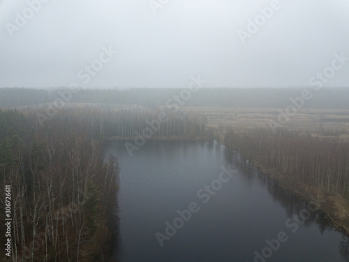 fog over forests and lakes in countryside. drone image from above