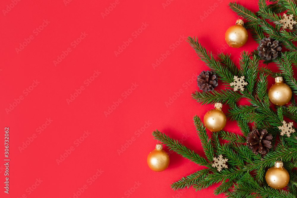 Christmas border with fir branches, cones, golden snowflakes and balls on a red background. Happy new year. Space for text.