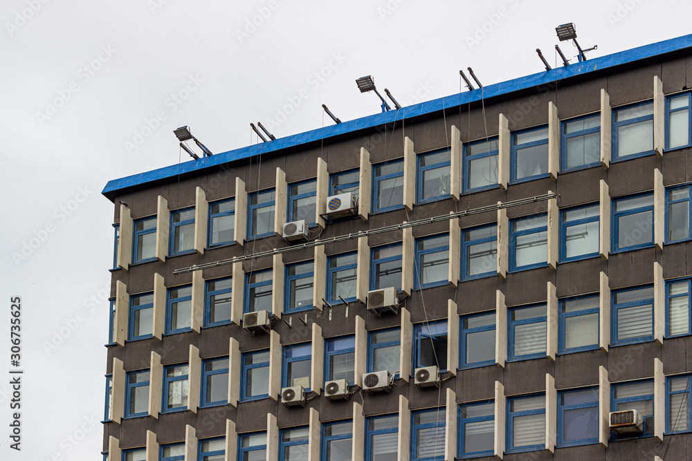 Fototapeta premium Perspective shoot of corner of old concrete public building with modern architecture style