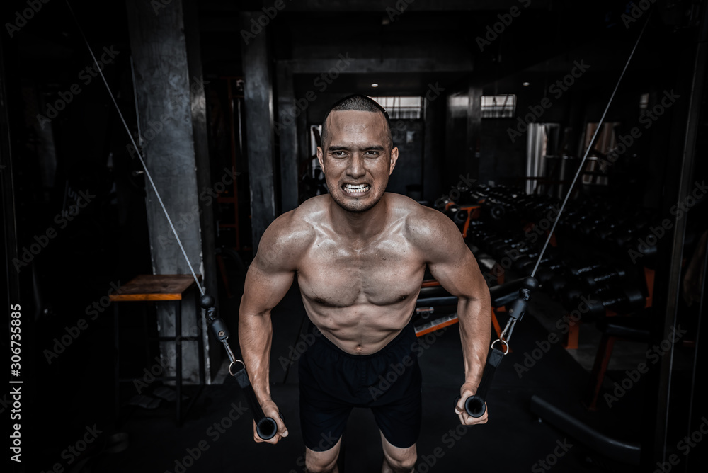 Portrait of asian man big muscle at the gym,Thailand people,Workout for good healthy,Body weight training,Fitness at the gym concept,Prank to abdominal muscles,Pull sling