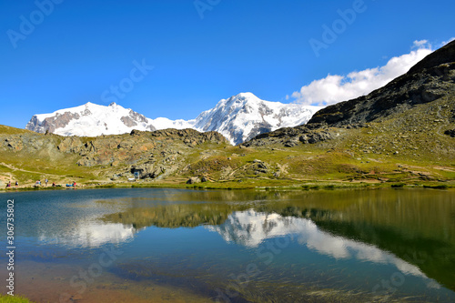 Reflection of the majestic Swiss Alps in the Riffelsee Lake, near the Gornergrat Ridge, Zermatt, Switzerland photo