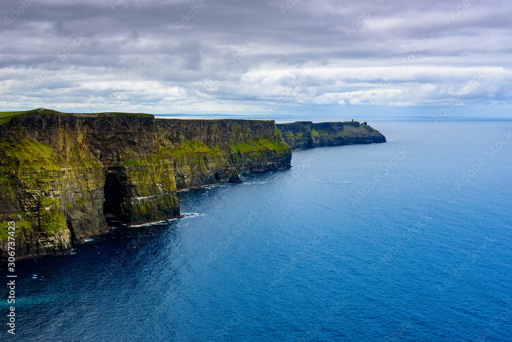 Blue sea at the foot of Moher cliffs