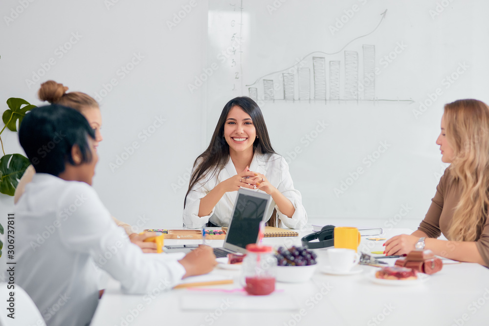 nice young business lady with partners in modern light office, smiling, sitting at desk, develop new project, start up, discuss and listen