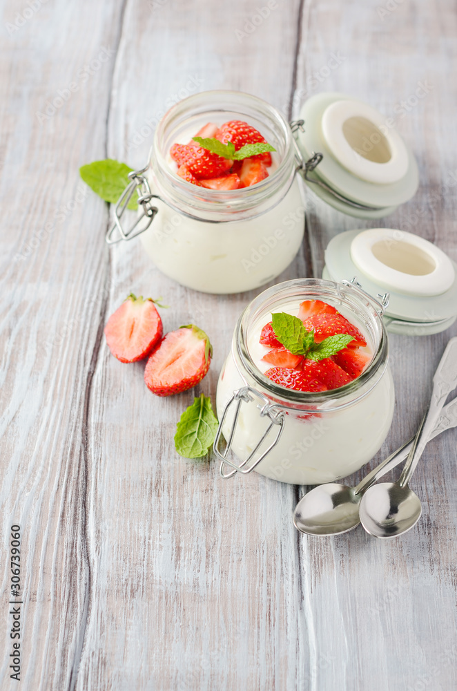Homemade natural yogurt with strawberries and mint, selective focus. Homemade natural yogurt with strawberries and mint, selective focus.
