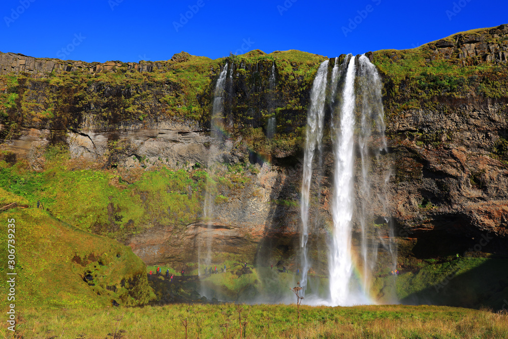 Seljalandfoss waterfall in sunny autumn day, Iceland, Europe. Famous tourist attraction