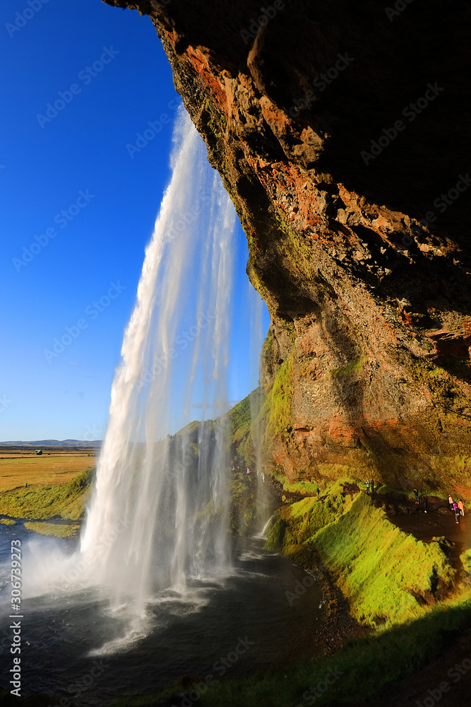 Seljalandfoss waterfall in sunny autumn day, Iceland, Europe. Famous tourist attraction
