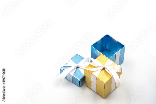 cute gift box set package with calm blue and golden colors tied by ribbon above white background
