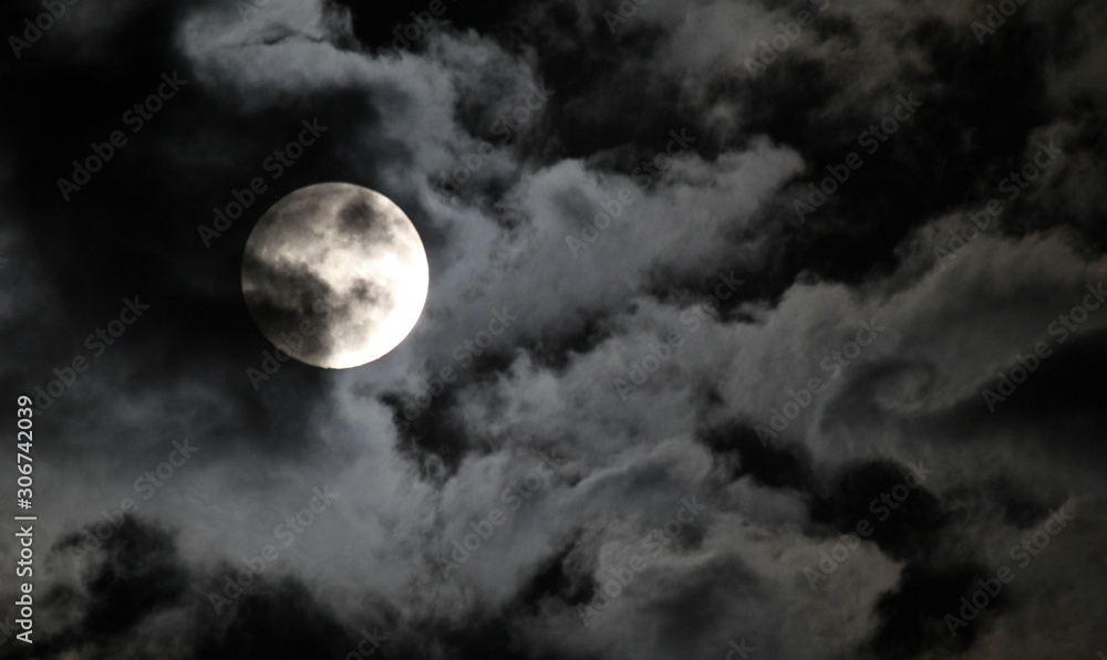 eerie sky with blue moon on halloween